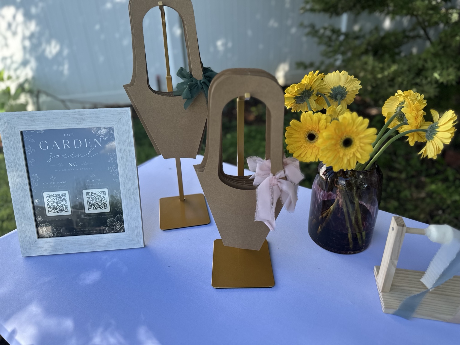 The Garden Social NC branded bouquet holders and event details